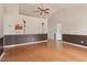 Spacious living area with gleaming hardwood floors and a ceiling fan at 34 Scotts Creek Run, Angier, NC 27501