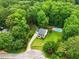 Aerial view of home with a well-manicured backyard, in-ground pool, and mature trees at 3421 Kistler Ct, Willow Springs, NC 27592
