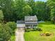 Aerial view of the two-story home with a front porch, manicured landscaping, and a swimming pool at 3421 Kistler Ct, Willow Springs, NC 27592