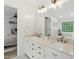Bathroom featuring double vanity, large mirror, tub, and natural light, providing a refreshing and functional space at 3421 Kistler Ct, Willow Springs, NC 27592