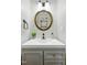 Stylish powder room showcasing a round mirror above a gray vanity with a modern black faucet at 3421 Kistler Ct, Willow Springs, NC 27592