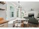 Bright dining area with window bench seating and views, complemented by modern light fixture and open to living area at 3421 Kistler Ct, Willow Springs, NC 27592