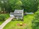 Aerial view of home with an expansive yard, inground pool with a slide and trampoline, and patio at 3421 Kistler Ct, Willow Springs, NC 27592