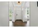 Bright foyer with wood floors leading to a naturally lit home through the front door at 3421 Kistler Ct, Willow Springs, NC 27592