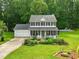 Charming two-story home boasts a well-manicured lawn, beautiful landscaping, and inviting front porch at 3421 Kistler Ct, Willow Springs, NC 27592