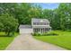 Beautifully maintained home features a classic design with a front porch, attached garage, and large yard at 3421 Kistler Ct, Willow Springs, NC 27592