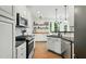 Bright kitchen with stainless steel appliances, granite counters, and hardwood floors at 3421 Kistler Ct, Willow Springs, NC 27592