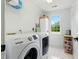Bright laundry room with Samsung washer and dryer, a window, and overhead shelving at 3421 Kistler Ct, Willow Springs, NC 27592