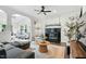 Elegant living room featuring a fireplace, ceiling fan, and a neutral color scheme at 3421 Kistler Ct, Willow Springs, NC 27592