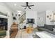 Cozy living room with a fireplace, staircase, ceiling fan, and hardwood floors at 3421 Kistler Ct, Willow Springs, NC 27592
