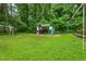 Backyard playground with play structure, slide, swing, and soccer goal on a grassy lot at 3421 Kistler Ct, Willow Springs, NC 27592