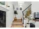 Elegant staircase with modern iron railings, stylish decor and lighting leading to the upper level at 3421 Kistler Ct, Willow Springs, NC 27592