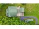 Bird's eye view reveals a well-maintained home with a striking green roof and paved driveway at 4053 Friendship Patterson Mill Road, Burlington, NC 27215