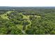 High-angle view of a charming home encircled by lush greenery, providing a serene and private retreat at 4053 Friendship Patterson Mill Road, Burlington, NC 27215