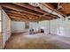 Unfinished basement with exposed beams and walls, offering potential for customization at 4053 Friendship Patterson Mill Road, Burlington, NC 27215