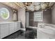 Bathroom features black tile, white vanity, and a large tub with a bright window at 4053 Friendship Patterson Mill Road, Burlington, NC 27215