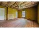 Shows unfinished bedroom with exposed insulation, wood-paneled walls, and hardwood floors at 4053 Friendship Patterson Mill Road, Burlington, NC 27215