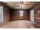 Bedroom showcasing wood paneling, original hardwood floors, and ceiling fan at 4053 Friendship Patterson Mill Road, Burlington, NC 27215
