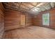 Bedroom highlighting unfinished wood paneling, hardwood floors and ceiling fan at 4053 Friendship Patterson Mill Road, Burlington, NC 27215