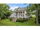 Stately two-story home with white siding, a metal roof, and a welcoming front porch with grand columns at 4053 Friendship Patterson Mill Road, Burlington, NC 27215