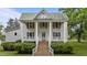 Charming two-story house with white siding and green shutters, featuring a covered front porch at 4053 Friendship Patterson Mill Road, Burlington, NC 27215