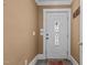 Image shows a white front door with decorative glass panel and vintage hardware at 4053 Friendship Patterson Mill Road, Burlington, NC 27215