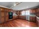 Well-equipped kitchen with cherry wood cabinets, stainless steel appliances, and a view from the window at 4053 Friendship Patterson Mill Road, Burlington, NC 27215
