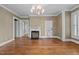 Elegant living room featuring a fireplace, chandelier, hardwood floors and natural light at 4053 Friendship Patterson Mill Road, Burlington, NC 27215