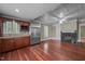 Spacious living room featuring a fireplace, hardwood floors, and stainless steel refrigerator at 4053 Friendship Patterson Mill Road, Burlington, NC 27215