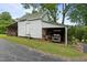 Rustic shed with a carport, providing ample storage space and shelter for a golf cart at 4053 Friendship Patterson Mill Road, Burlington, NC 27215