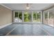 Charming sun room with tiled floors and panoramic views of the backyard at 4053 Friendship Patterson Mill Road, Burlington, NC 27215