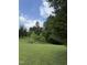 Expansive grassy yard with a variety of trees creating a secluded outdoor space at 4053 Friendship Patterson Mill Road, Burlington, NC 27215