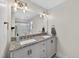 Bathroom featuring double sinks with granite countertops and a large mirror at 4067 Williams Mill Rd, Burlington, NC 27215