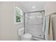 Bathroom showcasing a walk-in shower with subway tile and glass door, complemented by a window at 4067 Williams Mill Rd, Burlington, NC 27215