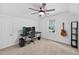 Carpeted bedroom with a ceiling fan featuring a modern desk, computer, and lots of natural light at 4067 Williams Mill Rd, Burlington, NC 27215