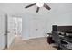 Carpeted bedroom featuring a modern ceiling fan, multiple closets, and a workspace at 4067 Williams Mill Rd, Burlington, NC 27215