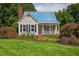 Charming single-Gathering home with a blue roof, brick chimney and a landscaped front yard at 4067 Williams Mill Rd, Burlington, NC 27215
