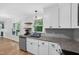 Well-lit kitchen features granite countertops, stainless steel appliances, and a view of the backyard at 4067 Williams Mill Rd, Burlington, NC 27215