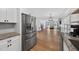 Bright, open-concept kitchen flows into a living room with hardwood floors and large windows at 4067 Williams Mill Rd, Burlington, NC 27215