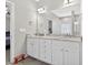 Bathroom featuring double sinks with granite countertops and modern lighting at 414 Fallingbrook Dr, Kenly, NC 27542