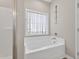 Bright bathroom showcasing a soaking tub next to the walk-in shower at 414 Fallingbrook Dr, Kenly, NC 27542
