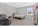 Cozy bedroom with natural light, comfy seating, and soft carpet provides a relaxing retreat at 414 Fallingbrook Dr, Kenly, NC 27542