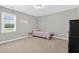 Bright bedroom with natural light, playful decor, and plush carpet offers a cheerful ambiance at 414 Fallingbrook Dr, Kenly, NC 27542