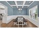 Formal dining room with stylish chandelier, wainscoting, and a large window at 414 Fallingbrook Dr, Kenly, NC 27542