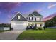 Charming two-story home with a manicured lawn, a two-car garage, and a welcoming front porch at 414 Fallingbrook Dr, Kenly, NC 27542