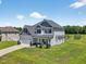 Beautiful two-story home with well-manicured lawn, charming details, and ample space at 414 Fallingbrook Dr, Kenly, NC 27542