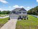 Stunning two-story home with manicured lawn, beautiful landscaping, and a welcoming appeal at 414 Fallingbrook Dr, Kenly, NC 27542