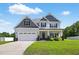 Beautiful two-story home with a well-maintained lawn and a spacious two-car garage at 414 Fallingbrook Dr, Kenly, NC 27542