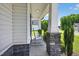 Charming front porch with stone pillar bases and inviting rocking chairs overlooking the lawn at 414 Fallingbrook Dr, Kenly, NC 27542