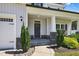 Inviting front porch with stone accents, manicured shrubs, and a charming entrance at 414 Fallingbrook Dr, Kenly, NC 27542